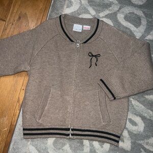 Toddler Girl Zara Tan Zip-Up Sweater with Black Trim and black bow
